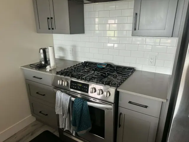 Clean kitchen counters, stove and tile backsplash in a Kamloops home